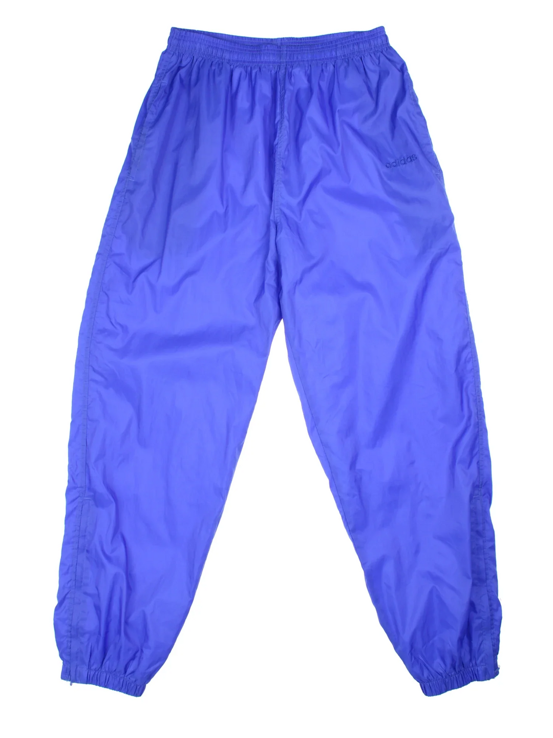 Adidas Tracksuit Bottoms in blue colourway. Side pockets, elasticated waist and the logo embroidered on the front.