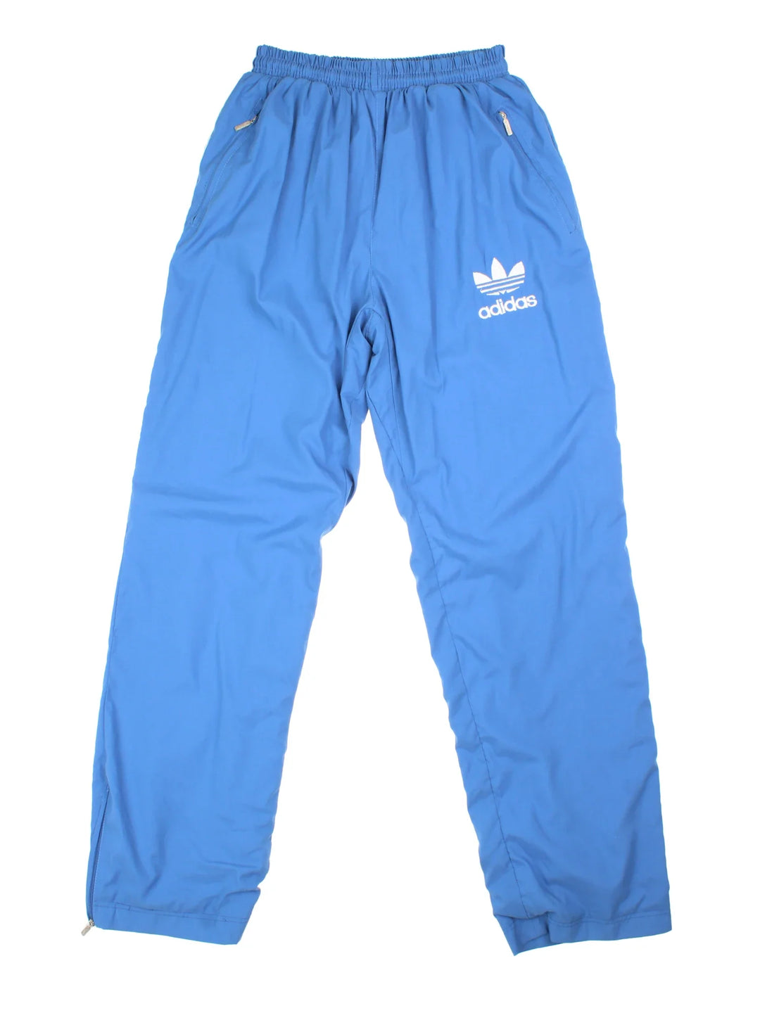 Adidas Tracksuit Bottoms in blue colourway. Side pockets, elasticated waist and the logo embroidered on the front.