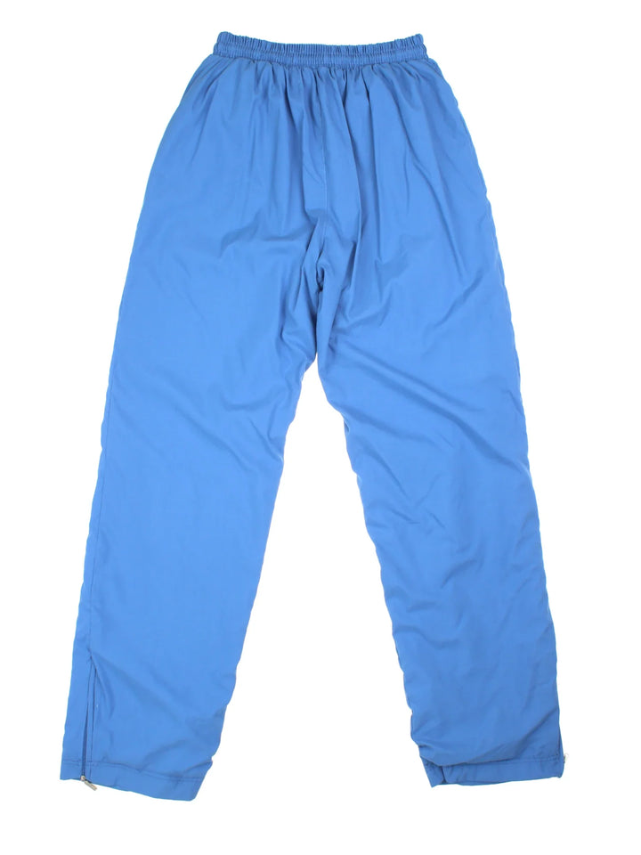 Adidas Tracksuit Bottoms in blue colourway. Side pockets, elasticated waist and the logo embroidered on the front.