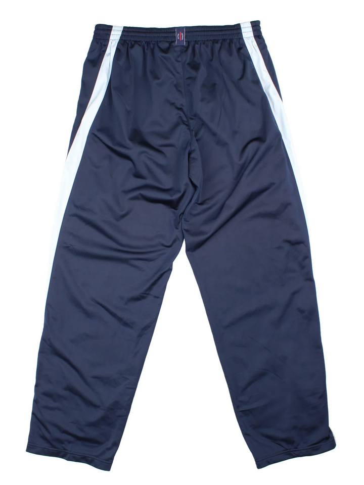 90's Diadora Tracksuit Bottoms in blue colourway. Side pockets, contrast piping and the logo embroidered on the front/back.