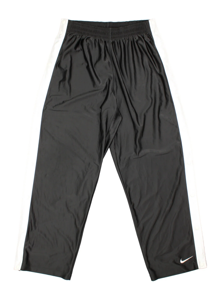 90's Nike Tracksuit Bottoms in black colourway. Side pockets, contrast piping and the logo embroidered on the front.