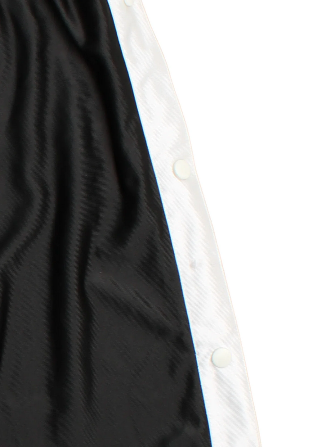 90's Nike Tracksuit Bottoms in black colourway. Side pockets, contrast piping and the logo embroidered on the front.