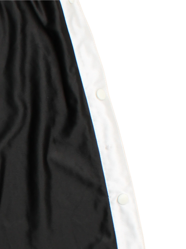 90's Nike Tracksuit Bottoms in black colourway. Side pockets, contrast piping and the logo embroidered on the front.