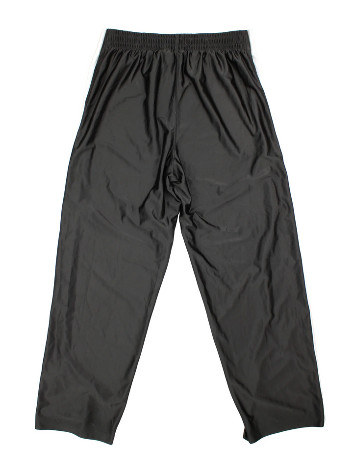 90's Nike Tracksuit Bottoms in black colourway. Side pockets, contrast piping and the logo embroidered on the front.