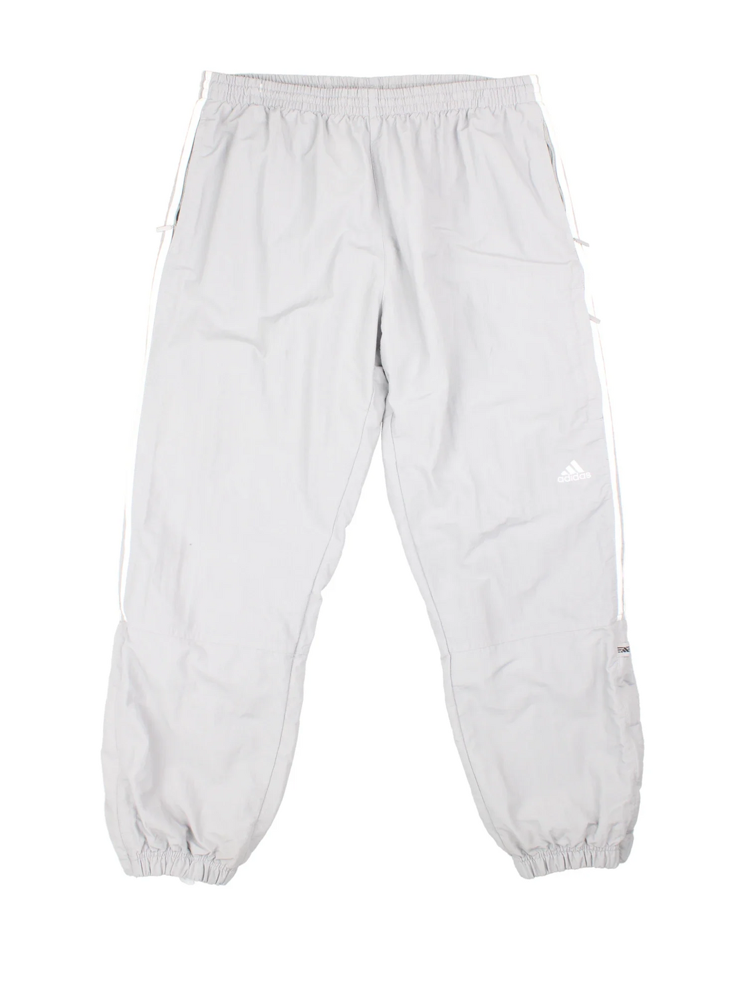 90's Adidas Tracksuit Bottoms in grey colourway. Side pockets, elasticated waist and the logo embroidered on the front.