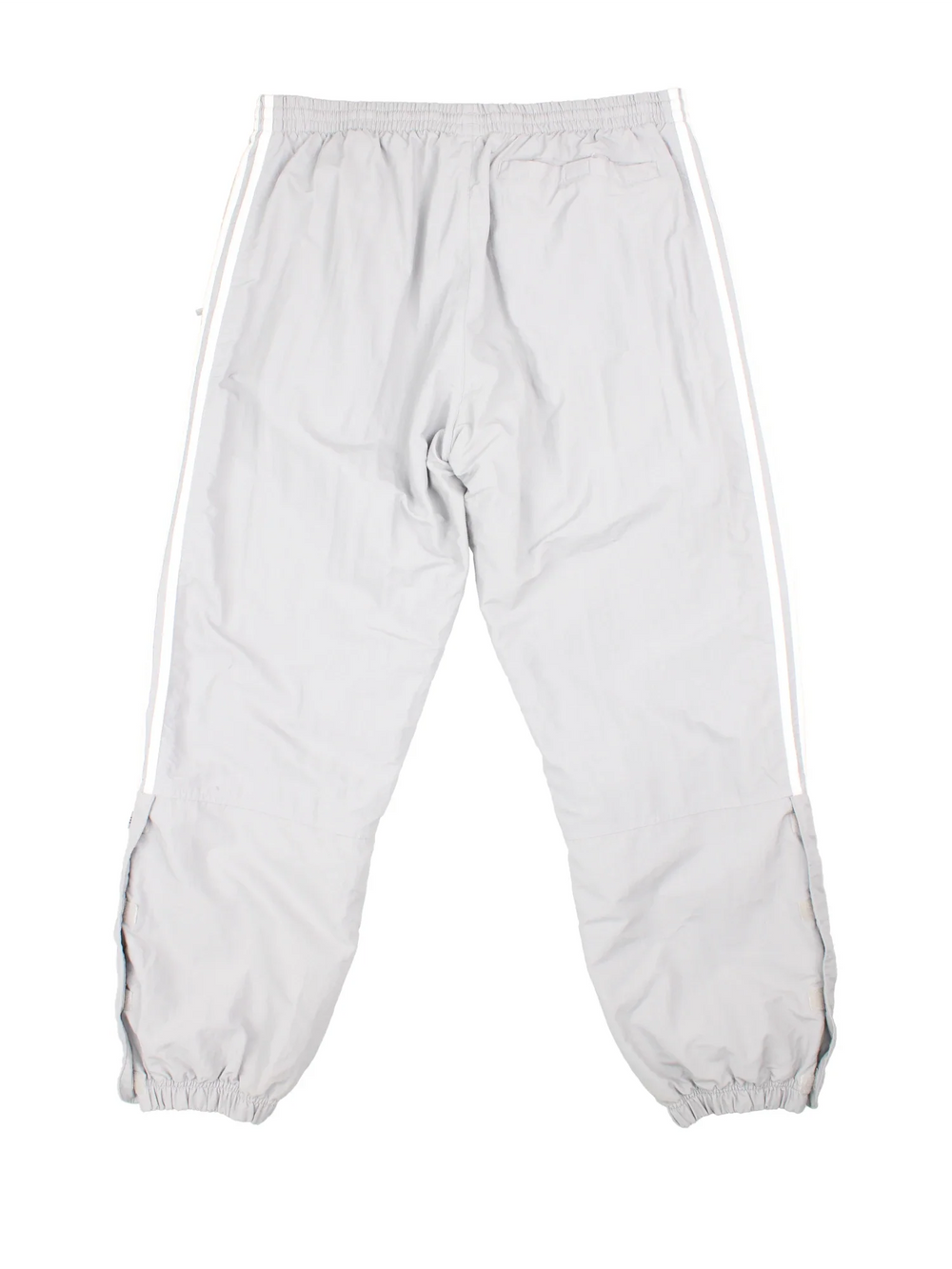 90's Adidas Tracksuit Bottoms in grey colourway. Side pockets, elasticated waist and the logo embroidered on the front.