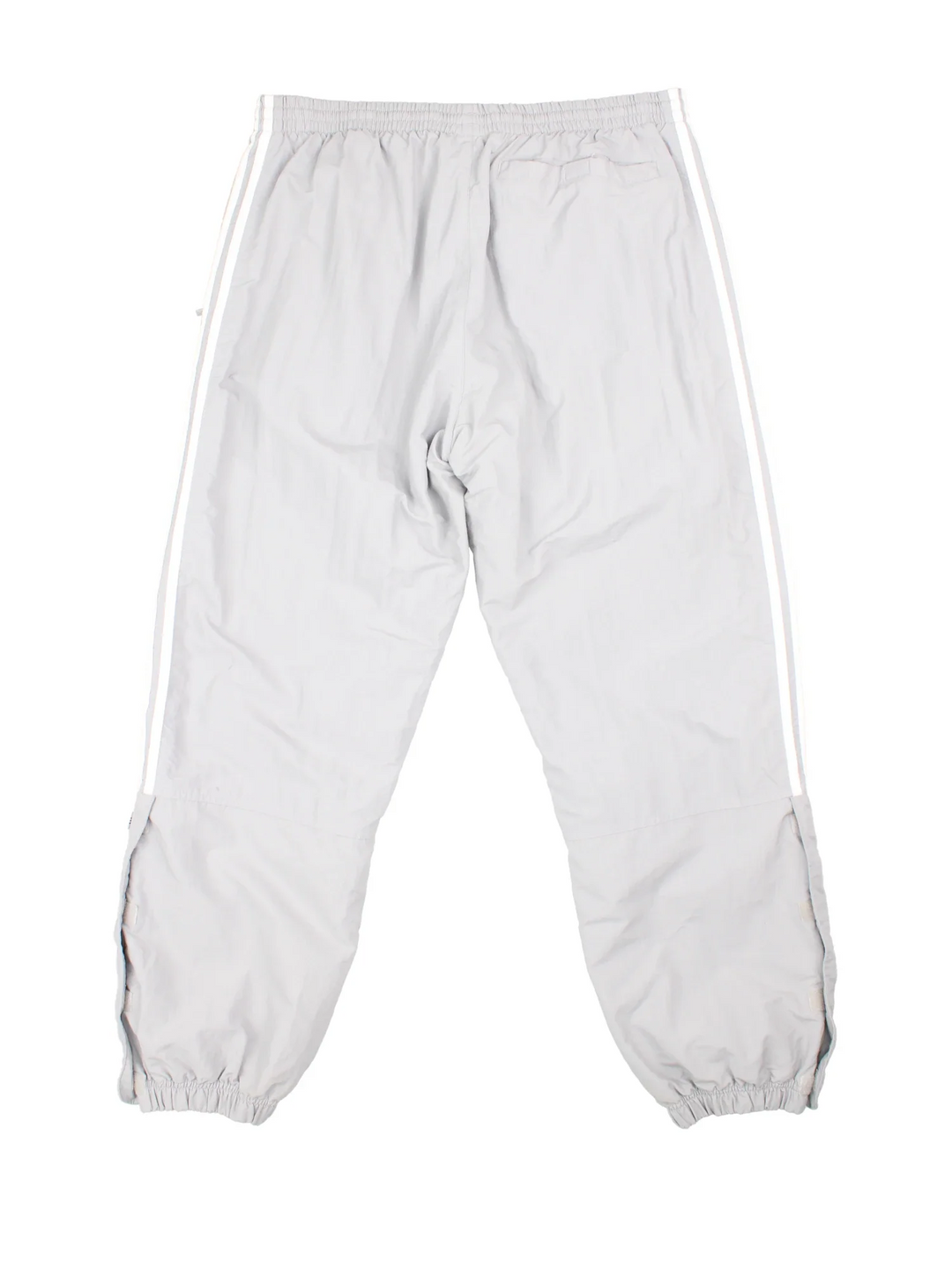 90's Adidas Tracksuit Bottoms in grey colourway. Side pockets, elasticated waist and the logo embroidered on the front.