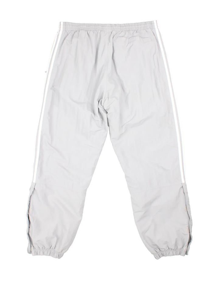 90's Adidas Tracksuit Bottoms in grey colourway. Side pockets, elasticated waist and the logo embroidered on the front.