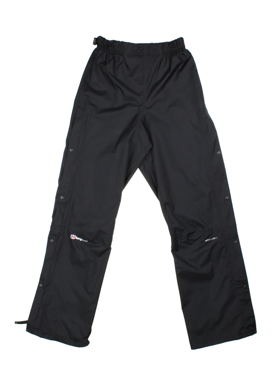 Berghaus Hydroshell Hike Trousers in a black colourway, does not have pockets, has an adjustable elasticated waist, popper button and zip down the side of the legs, and the logo printed on the front.