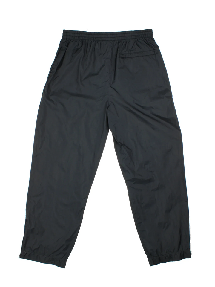 Vintage Adidas Tracksuit Shell Pants in a black colourway with pockets, adjustabe elasticated waist with drawstring and has the logo embroidered on the front.