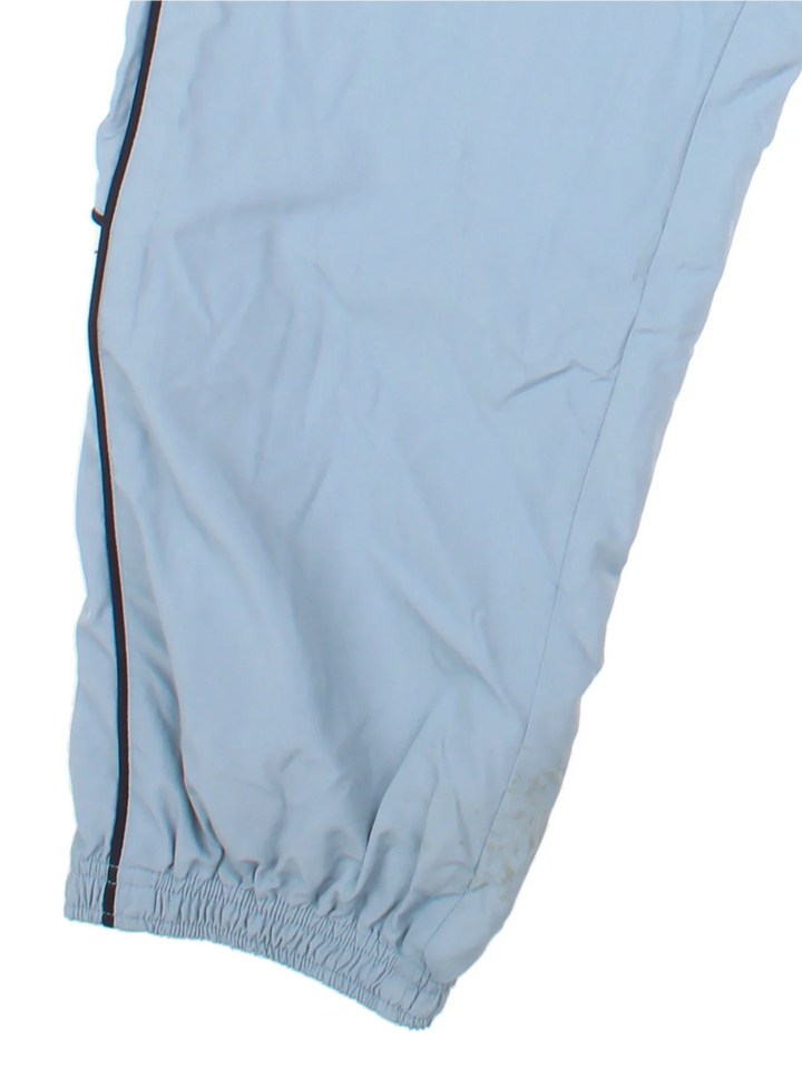 Reebok Tracksuit Bottoms in a blue colourway with stripes going down the sides, pockets, elasticated waist with drawstring, and the logo embroidered on the front and down the sides.