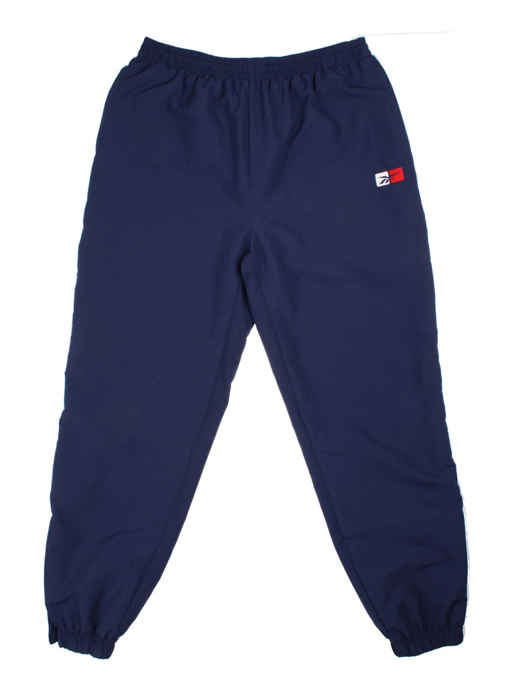 Reebok Tracksuit Bottoms in a blue colourway with pockets, elasticated waist with drawstring, and the logo embroidered on the front.