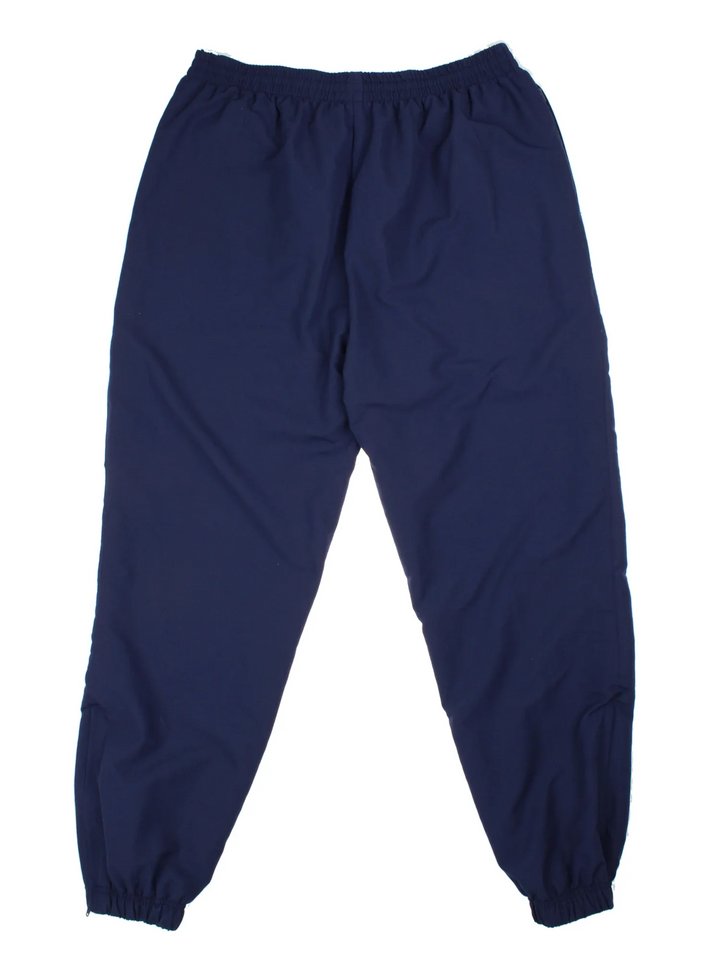 Reebok Tracksuit Bottoms in a blue colourway with pockets, elasticated waist with drawstring, and the logo embroidered on the front.