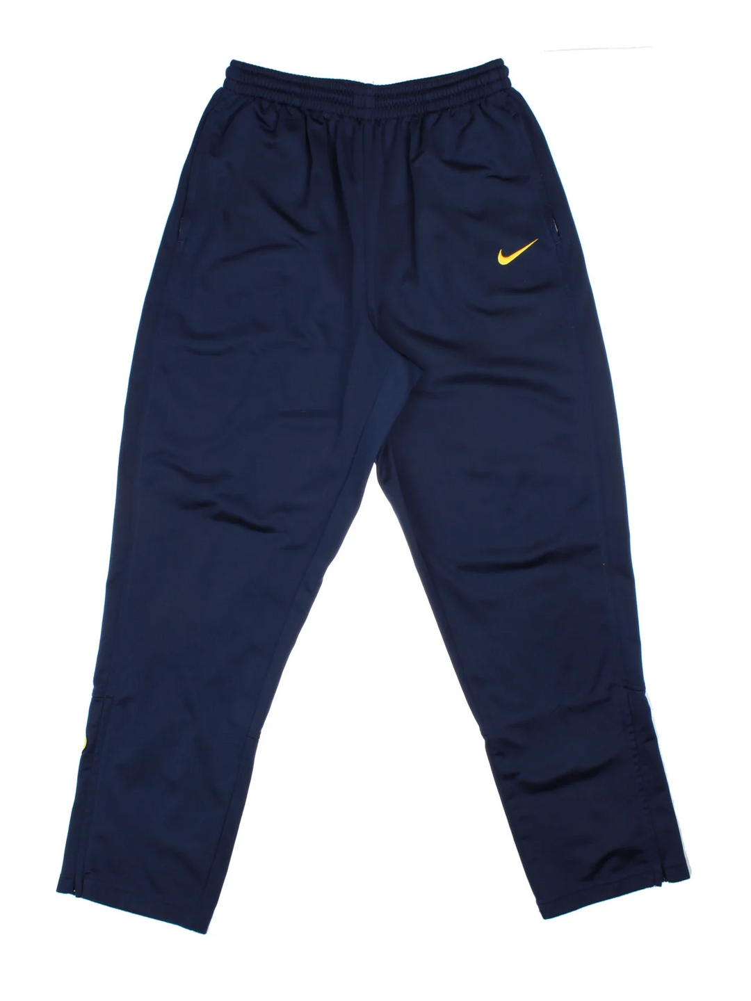 Nike Tracksuit Bottoms in a blue colourway with zip up side pockets, elasticated waist with drawstring, and the swoosh logo embroidered on the front and back.