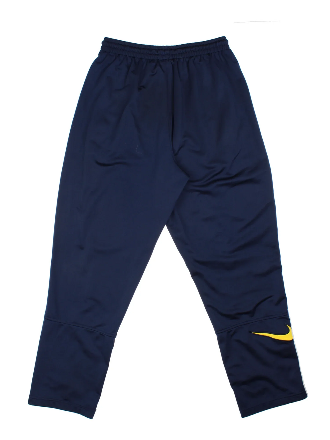 Nike Tracksuit Bottoms in a blue colourway with zip up side pockets, elasticated waist with drawstring, and the swoosh logo embroidered on the front and back.