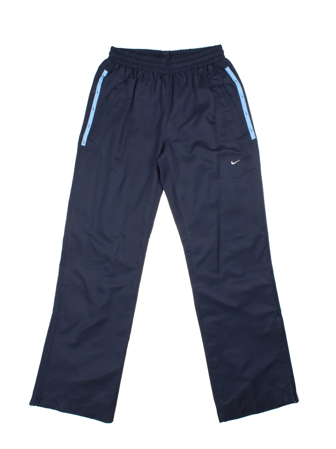 Y2K Nike Tracksuit Bottoms in a blue colourway with pockets, elasticated waist with drawstring, and has the logo embroidered on the front.