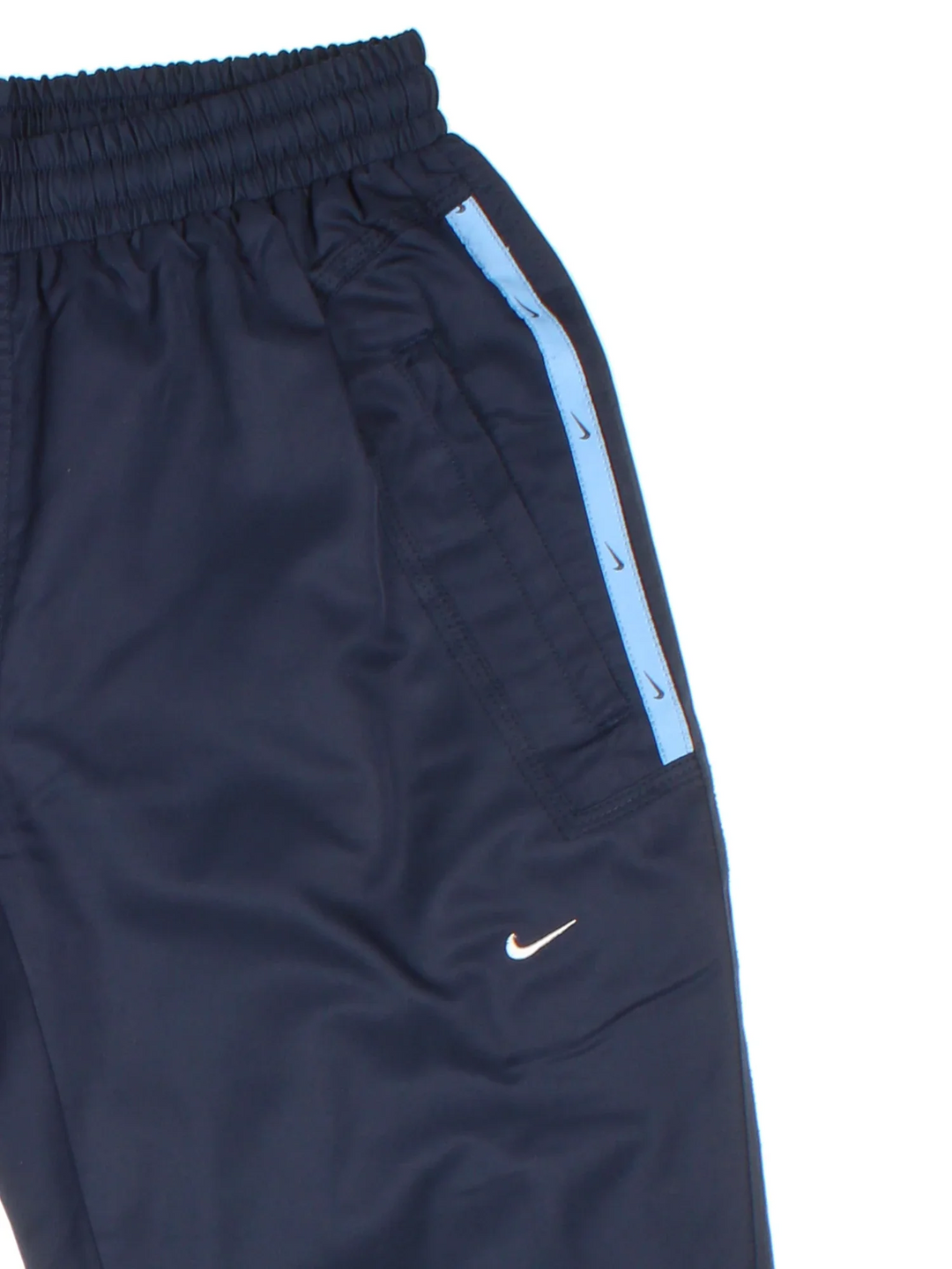 Y2K Nike Tracksuit Bottoms in a blue colourway with pockets, elasticated waist with drawstring, and has the logo embroidered on the front.