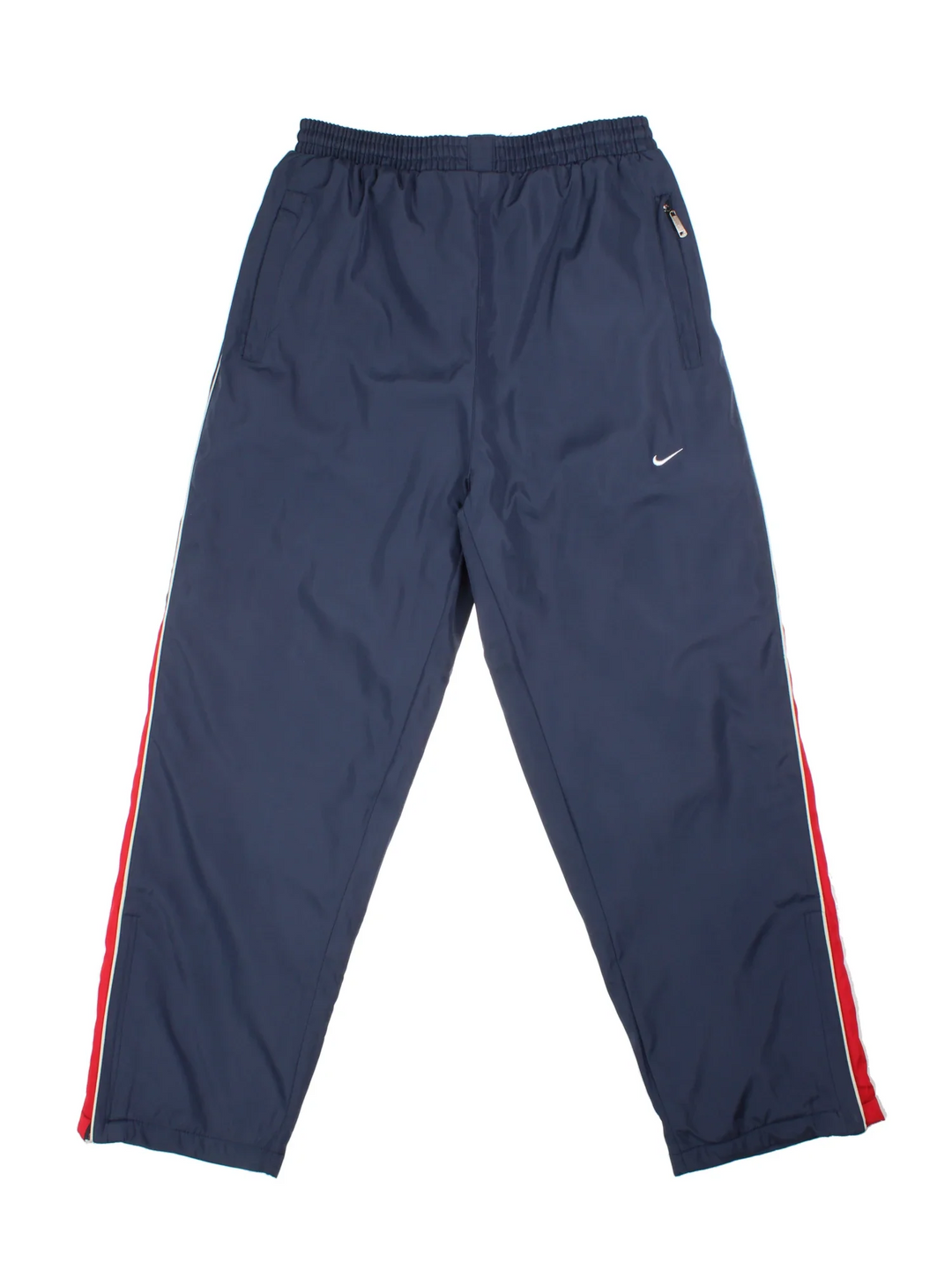 Nike Thermal Tracksuit Bottoms in a blue colourway with red and white panelling on the sides, has pockets, elasticated waist with drawstring, insulated thermal lining, and the swoosh logo embroidered on the front.