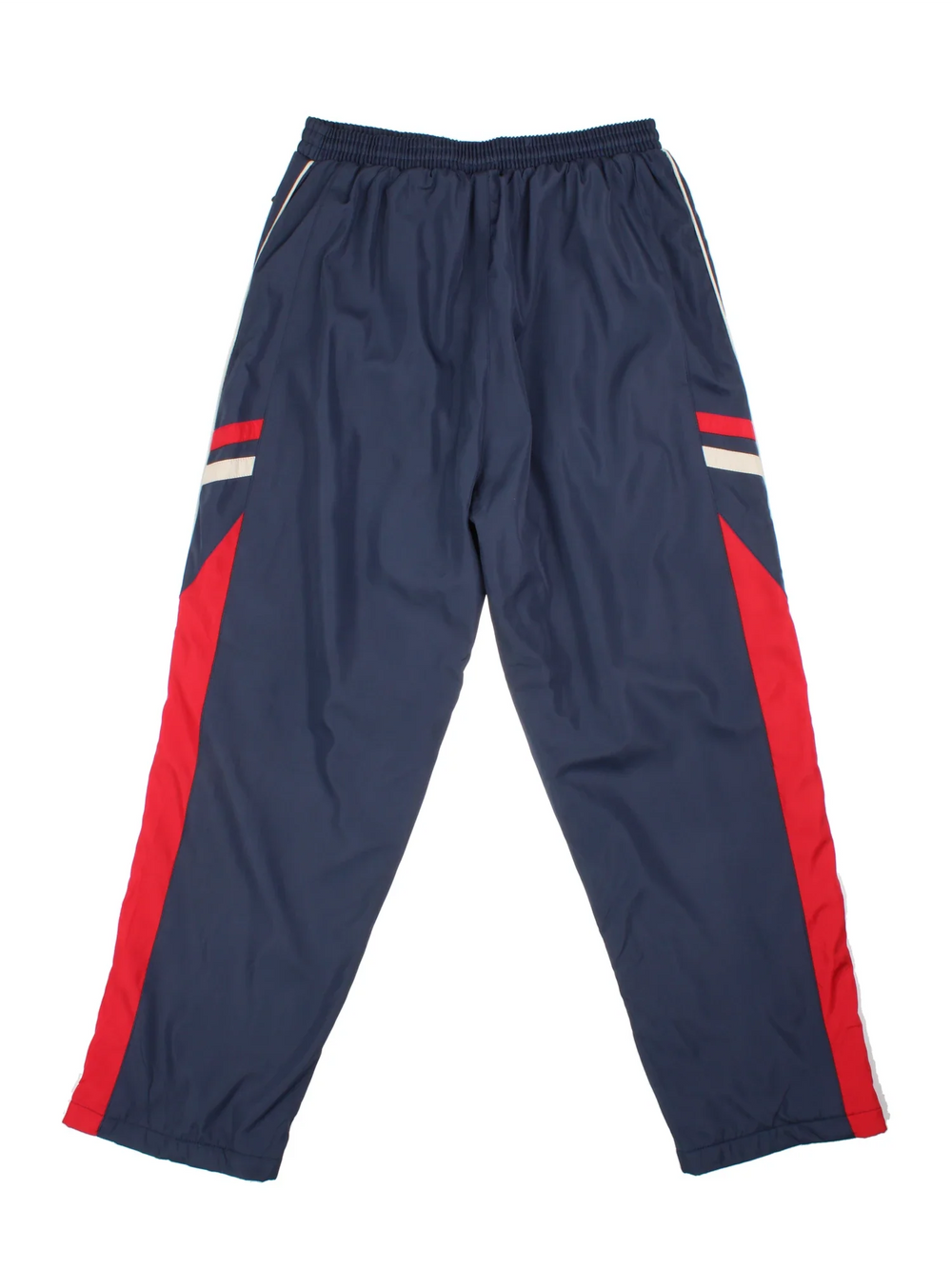 Nike Thermal Tracksuit Bottoms in a blue colourway with red and white panelling on the sides, has pockets, elasticated waist with drawstring, insulated thermal lining, and the swoosh logo embroidered on the front.