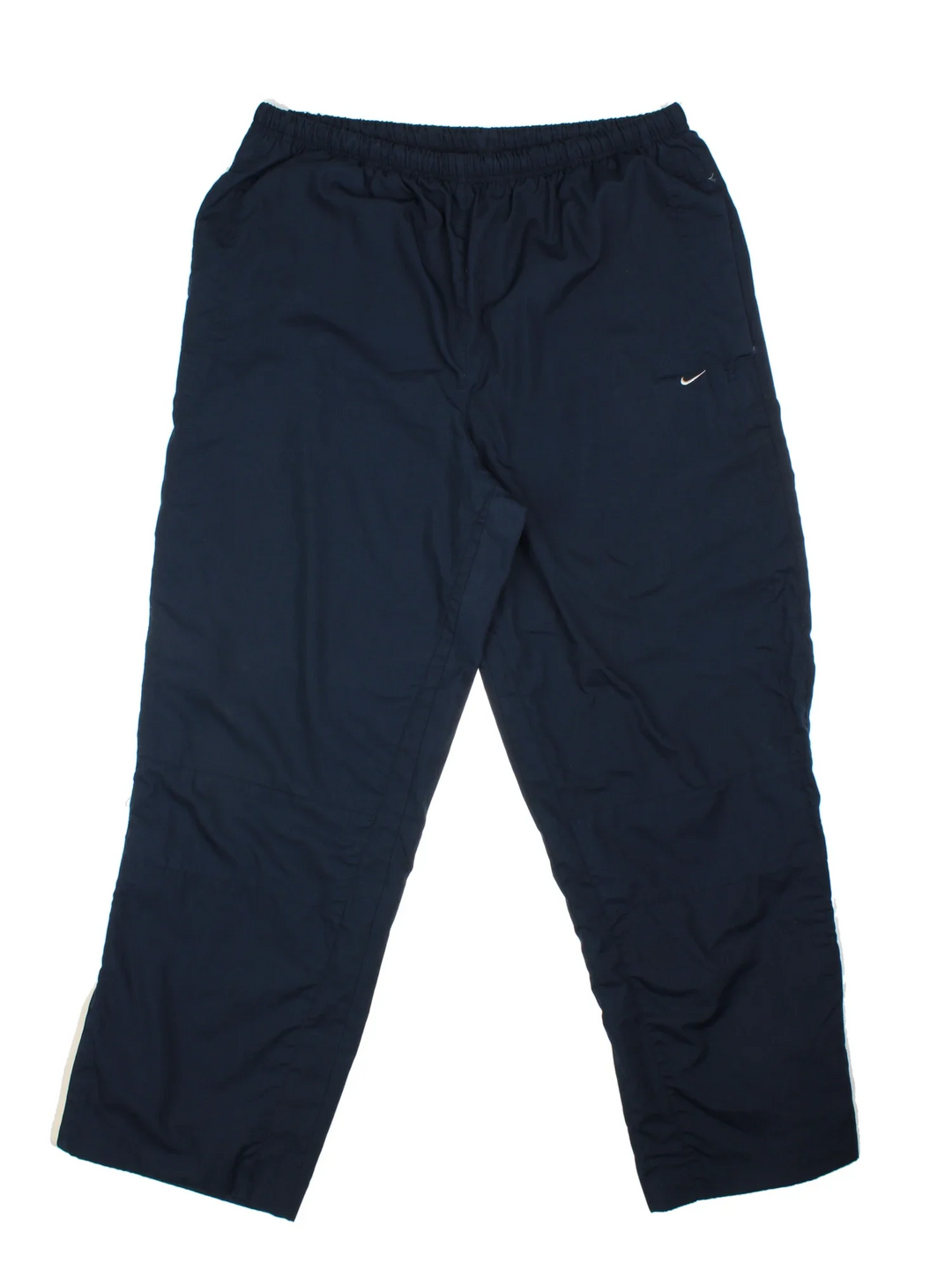 Nike Tracksuit Bottoms in a blue colourway with pockets, elasticated waist with drawstring, cotton lining, and the swoosh logo embroidered on the front.