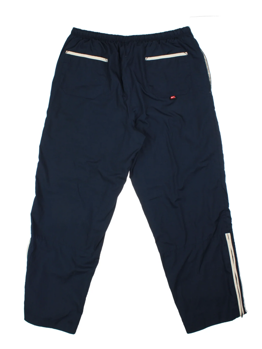 Nike Tracksuit Bottoms in a blue colourway with pockets, elasticated waist with drawstring, cotton lining, and the swoosh logo embroidered on the front.