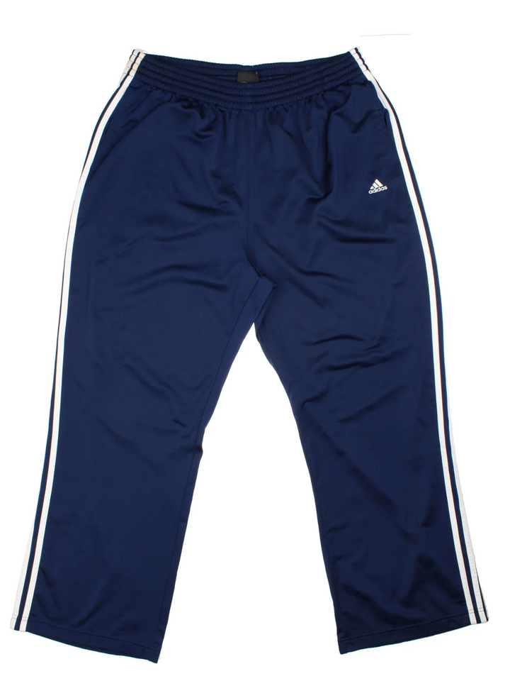 Adidas Tracksuit Bottoms in a blue colourway with the iconic three stripes down the sides, has pockets, elasticated waist with drawstring, and the logo embroidered on the front.