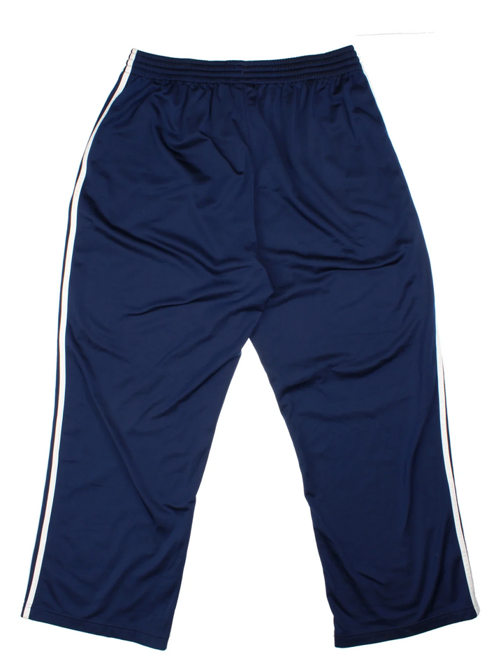 Adidas Tracksuit Bottoms in a blue colourway with the iconic three stripes down the sides, has pockets, elasticated waist with drawstring, and the logo embroidered on the front.
