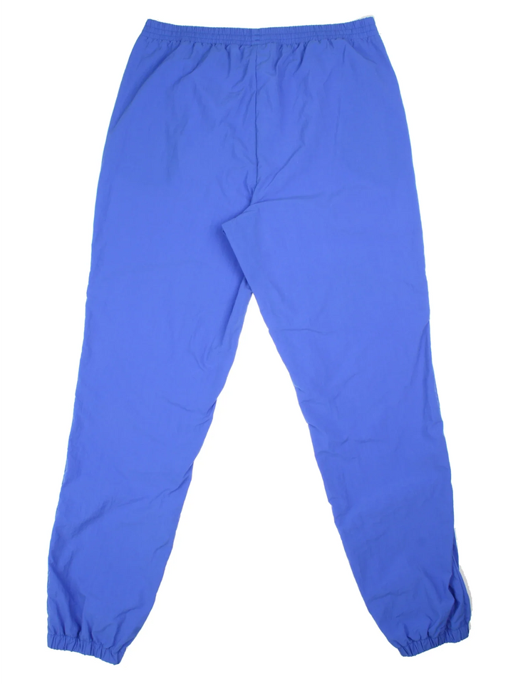 Vintage 80's Adidas Olympics Spirit Of The Games Tracksuit Bottoms in a blue colourway with pockets, elasticated waist, and the logo printed on the front.