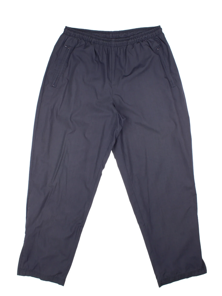 90's Nike Tracksuit Bottoms in a grey colourway with pockets, elasticated waist with drawstring, mesh lining, and has the swoosh logo embroidered on the back.