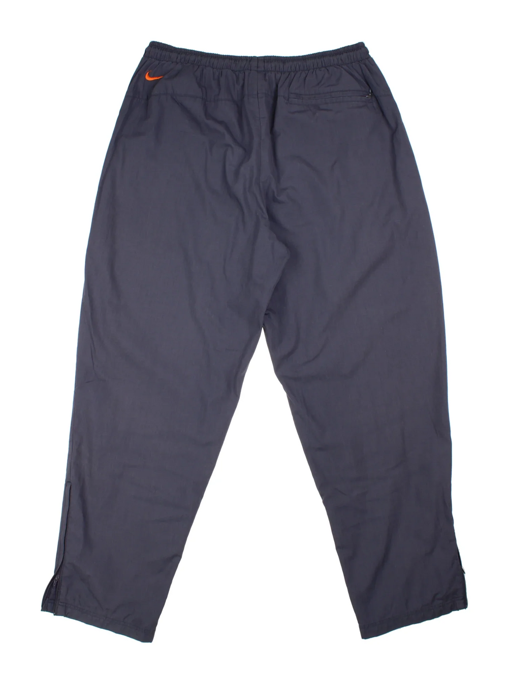 90's Nike Tracksuit Bottoms in a grey colourway with pockets, elasticated waist with drawstring, mesh lining, and has the swoosh logo embroidered on the back.