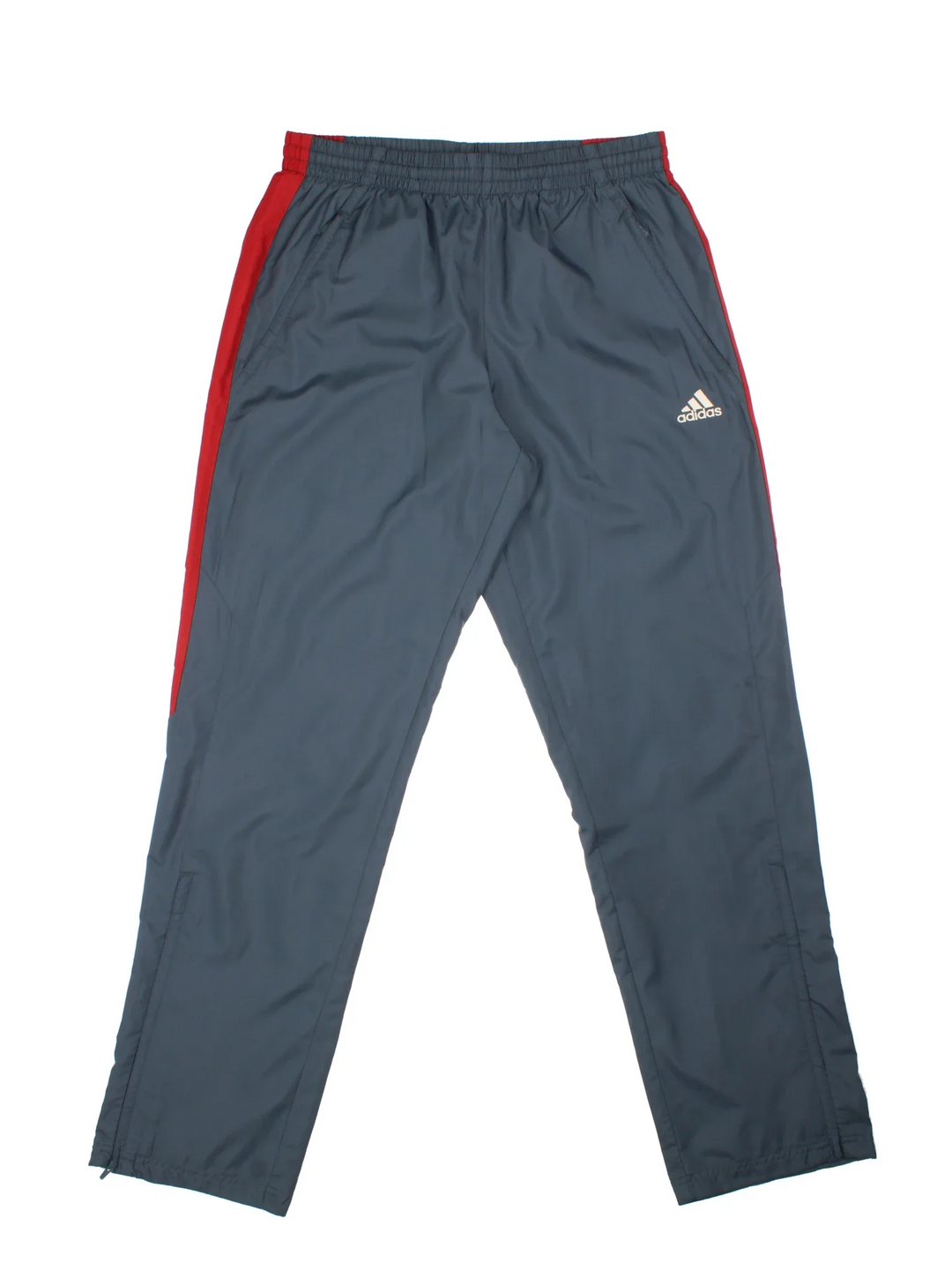 Adidas Tracksuit Bottoms in a grey colourway with red panelling, has pockets, elasticated waist with drawstring, mesh lining, and the logo embroidered on the front.