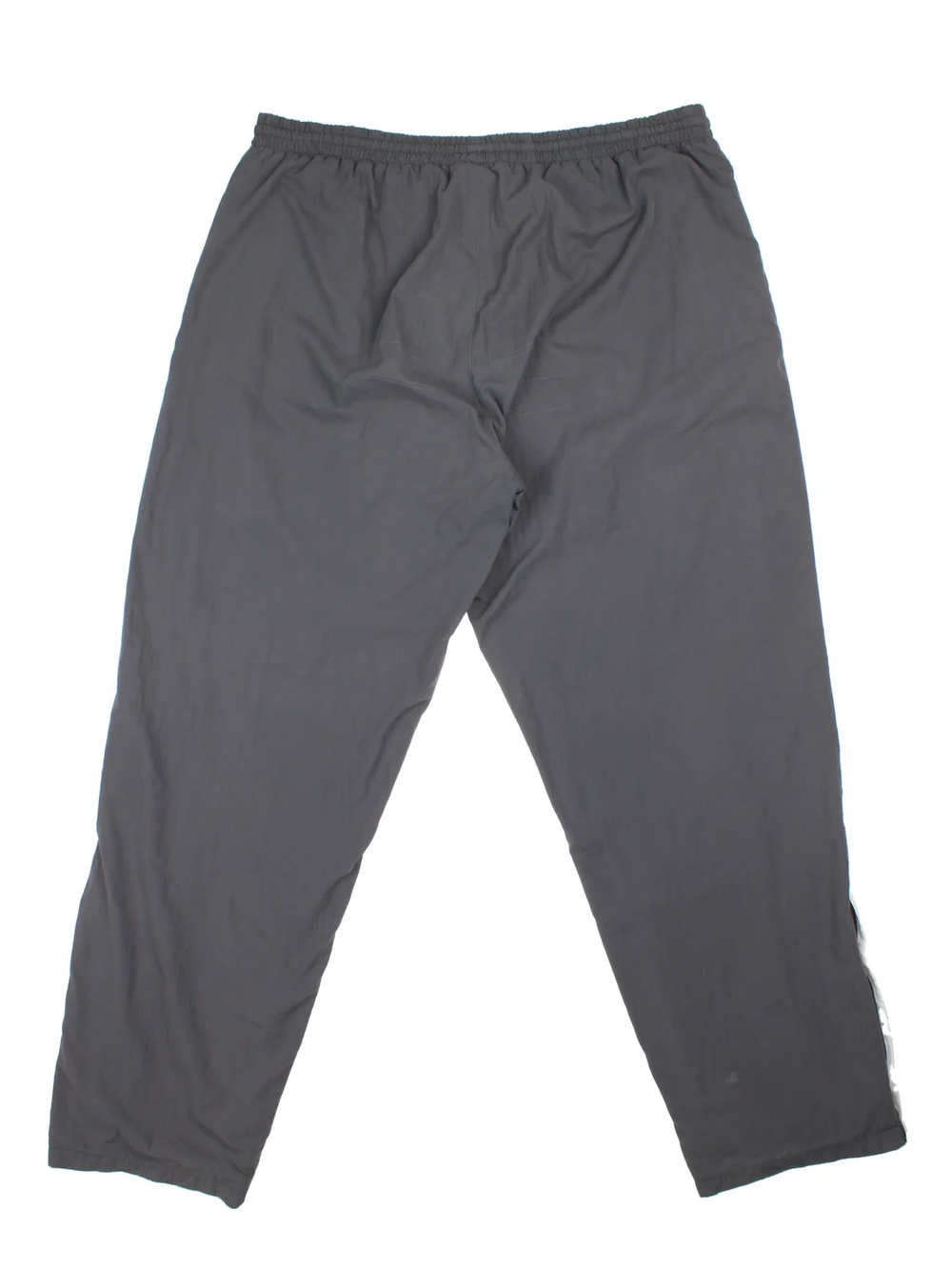 Vintage Lotto Shell Pants in a grey colourway with pockets, elasticated waist with drawstring, cotton blend lining, and the logo embroidered on the front.