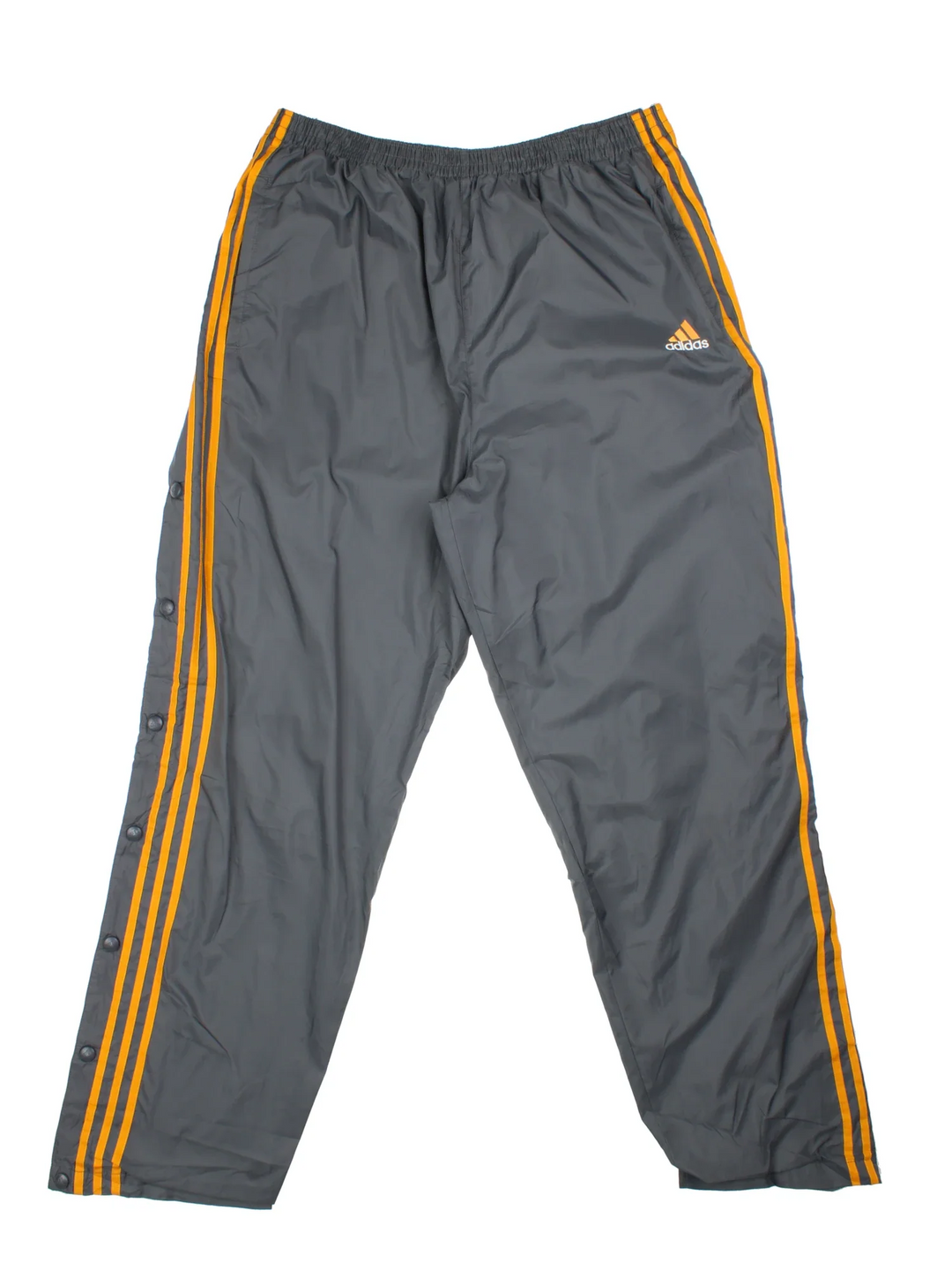 Vintage Adidas Popper Tracksuit Pants in a grey colourway with the iconic three stripes in orange down the sides, has pockets, elasticated waist, and the logo embroidered on the front.