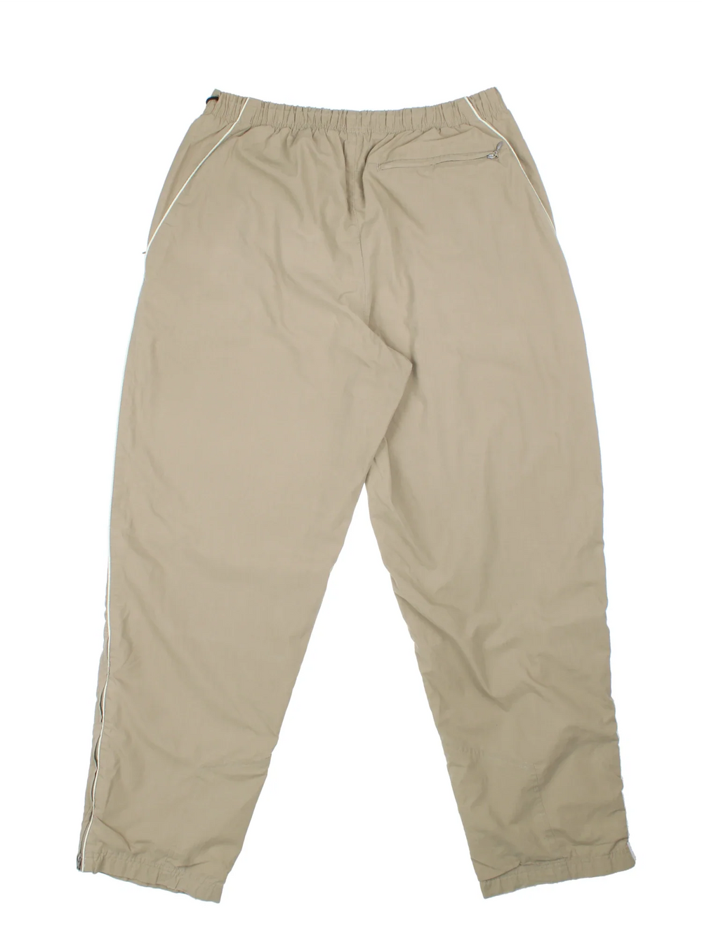 Nike Tracksuit Bottoms in a tan colourway with pockets, elasticated waist, cotton blend lining, and the swoosh logo embroidered on the front.