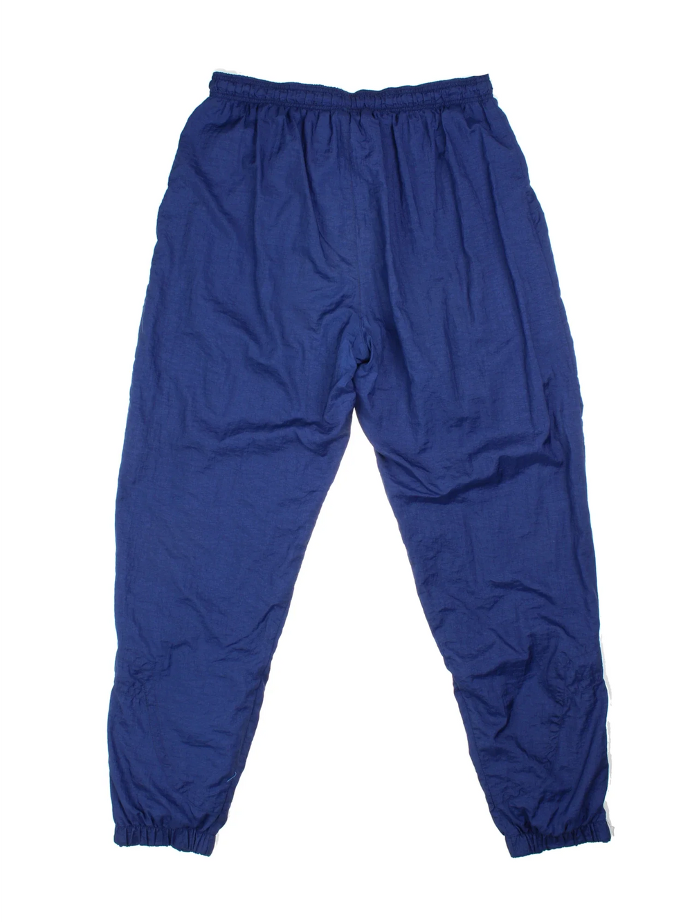 Vintage 90's Nike Shell Tracksuit Bottoms in blue colourway, has pockets, elasticated waist with drawstring, cotton blend lining, and the logo embroidered on the front.
