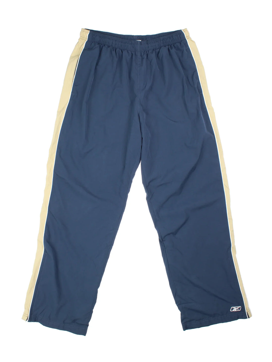 Reebok Tracksuit Bottoms in blue colourway, has pockets, elasticated waist with drawstring, cotton blend lining, and the logo embroidered on the front by the hem.