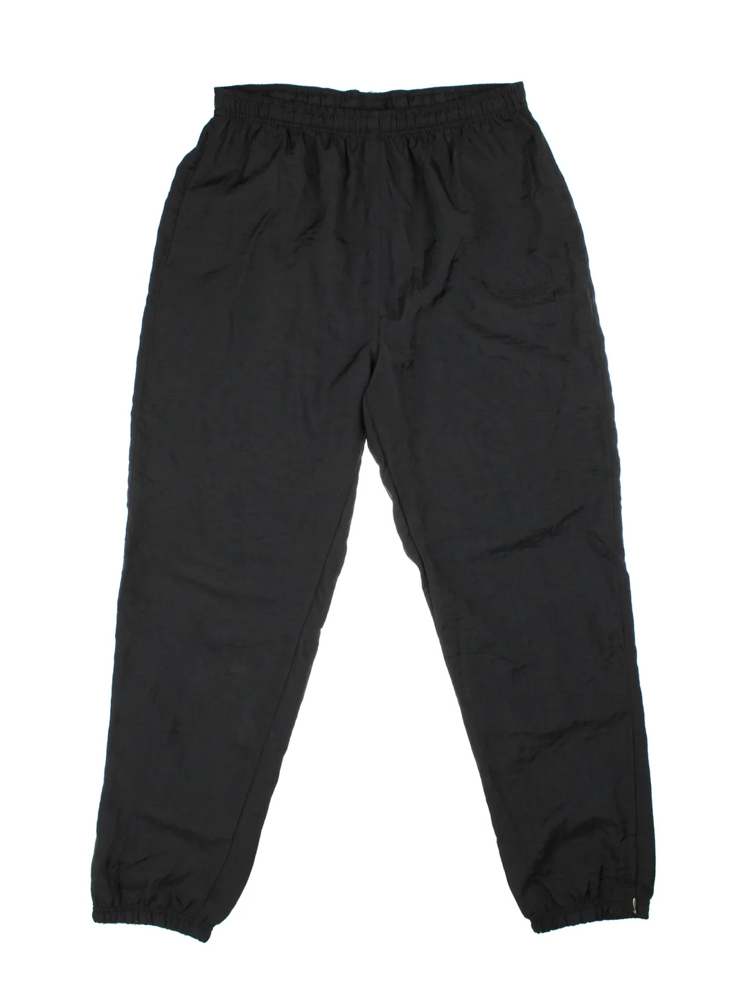 Vintage Adidas Shell Pants in black colourway, has pockets, elasticated waist with drawstring, and the logo embroidered on the front.