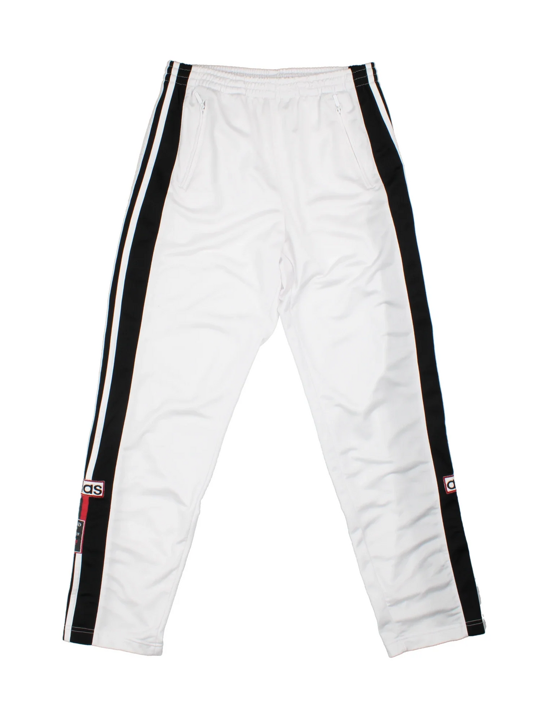 Vintage 90's Adidas Popper Tracksuit Bottoms in white and black colourway, has pockets, elasticated waist with drawstring, and the logo embroidered down the side of the legs alongside popper buttons.