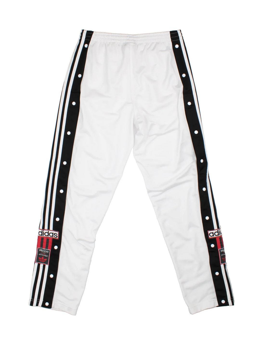 Vintage 90's Adidas Popper Tracksuit Bottoms in white and black colourway, has pockets, elasticated waist with drawstring, and the logo embroidered down the side of the legs alongside popper buttons.