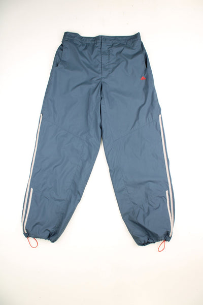 Vintage Adidas tracksuit bottoms featuring embroidered logo and signature three stripe detailing. 