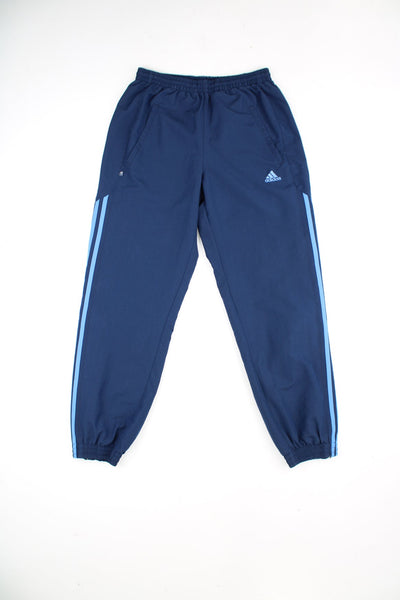 Blue Adidas tracksuit bottoms featuring embroidered logo, elasticated drawstring waist and signature three stripe detail on each leg.