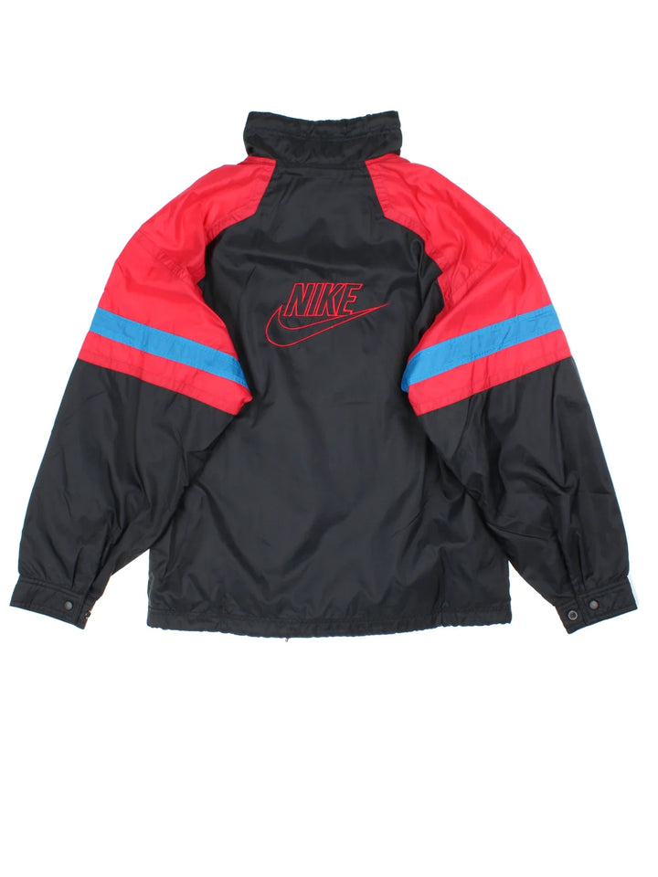 80's Nike Tracksuit Jacket in a black/red colourway. Zip up fastening, side pockets, jersey lining and has the logo embroidered on the front/back.