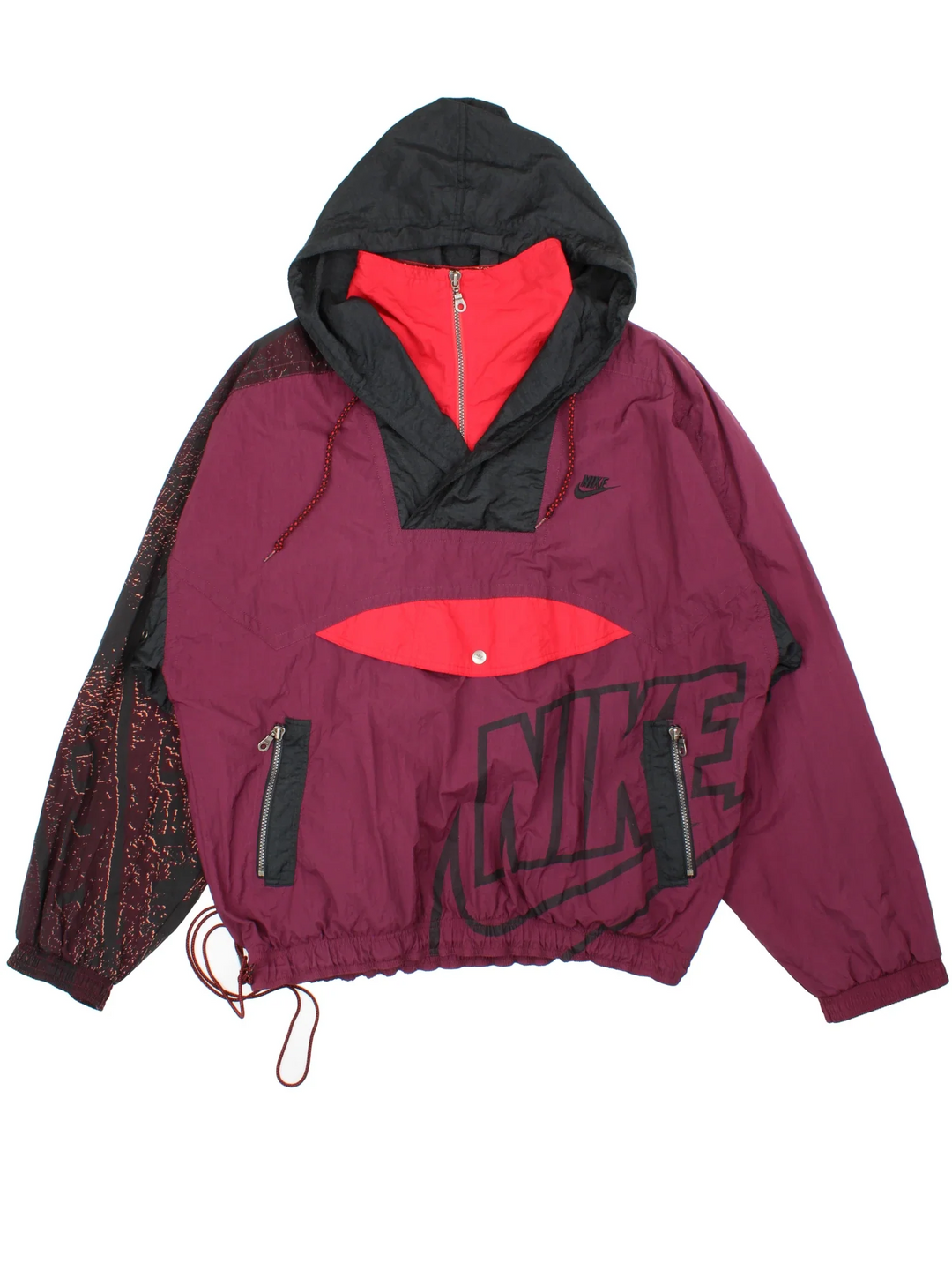 Vintage 80's Nike Anorak Jacket in a purple and black colourway. 1/4 zip closure and has multiple pockets, patterned and branding details, and the logo embroidered on the front.