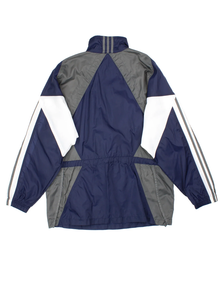 Vintage Adidas Windbreaker in a blue colourway. Half zip up closure and has side pockets with the logo embroidered on the front.