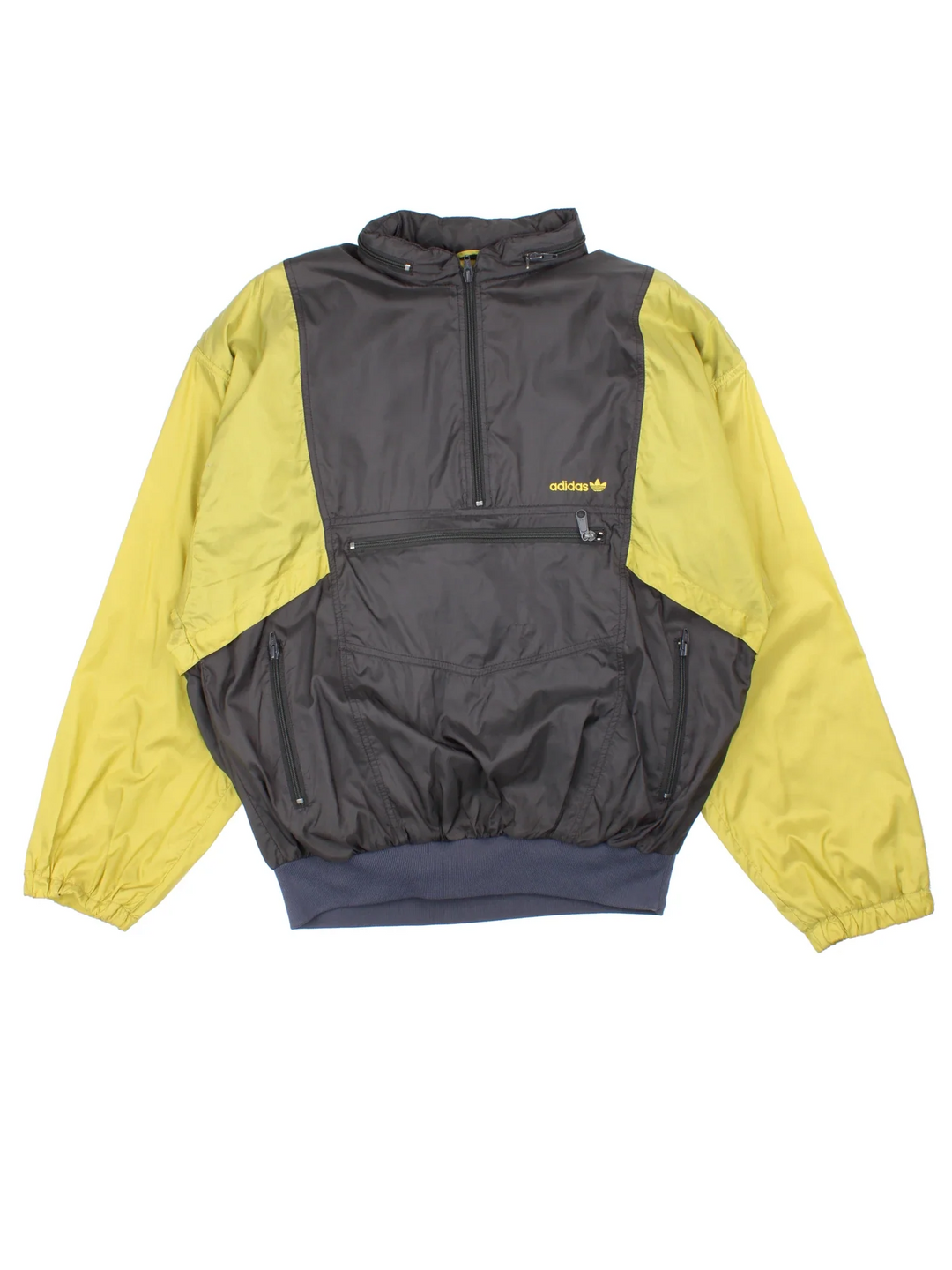 Vintage Adidas Windbreaker in a grey and yellow colourway. Half zip up closure and has multiple pockets, hiiden hood, the logo embroidered on the front, and can turn into a bag.
