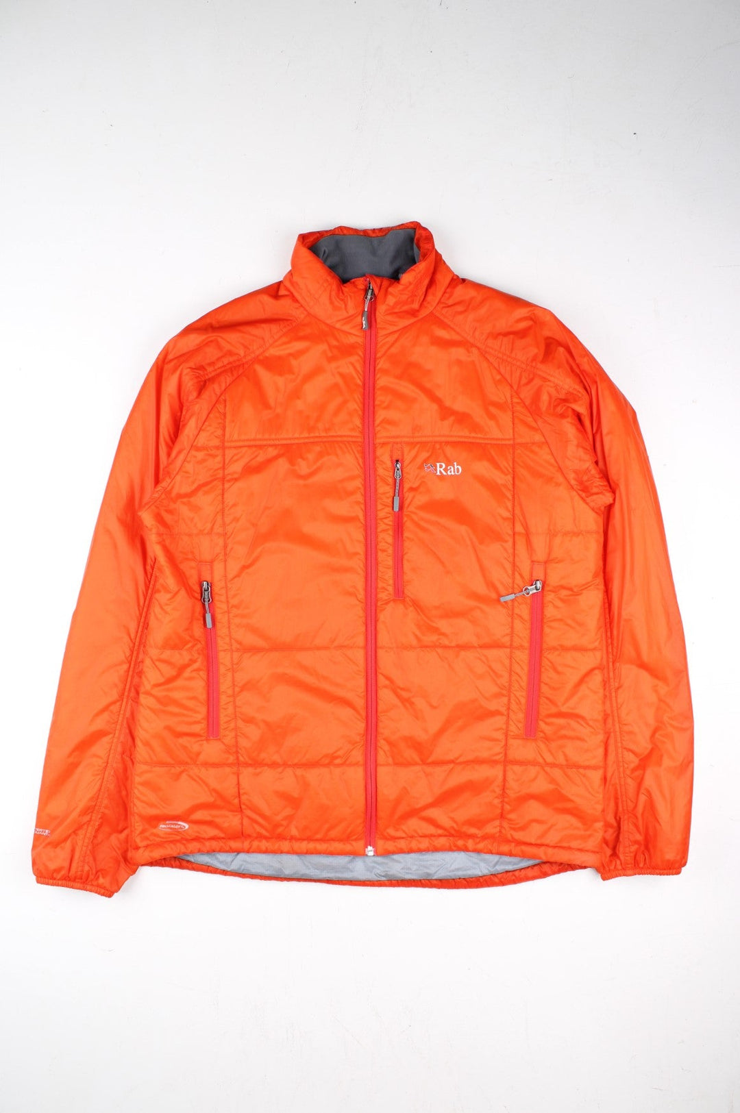 Rab Generator Lightweight Puffer Jacket in a orange colourway. Full zip with multiple pockets, drawstring hem and small classic logo on the front.