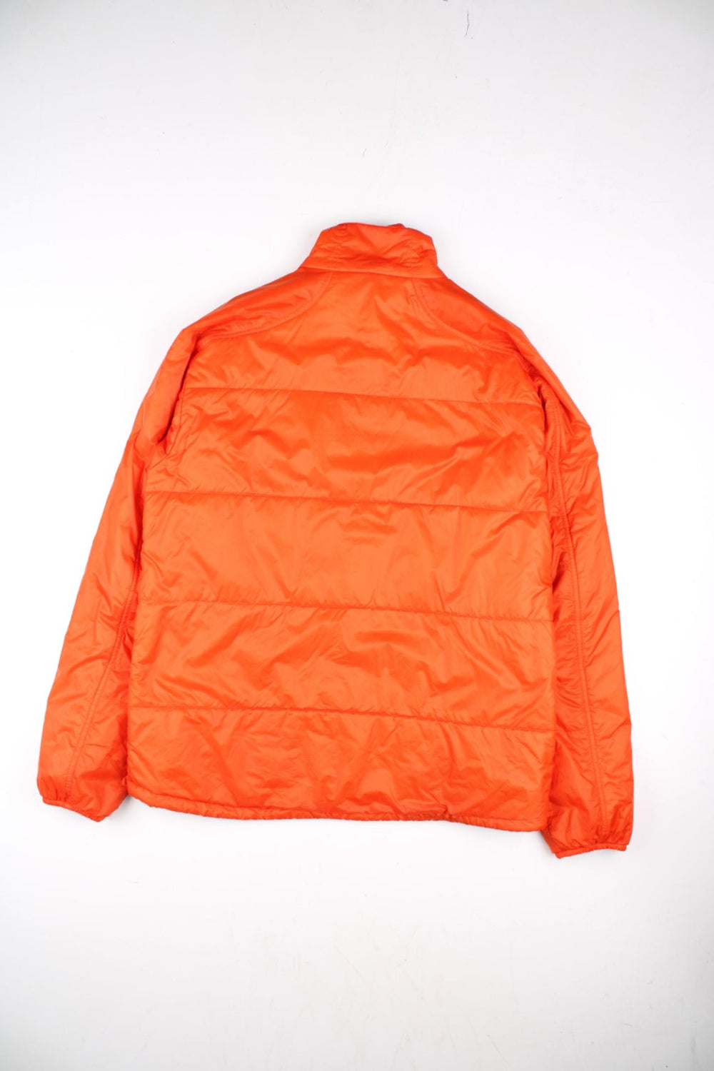 Rab Generator Lightweight Puffer Jacket in a orange colourway. Full zip with multiple pockets, drawstring hem and small classic logo on the front.