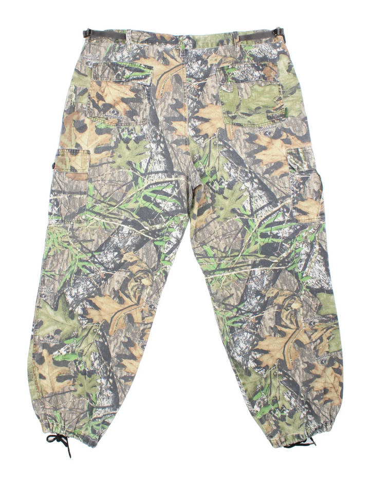 Mossy Oak Real Tree Camo Cargo Trousers in a green and brown colourway with multiple pockets.