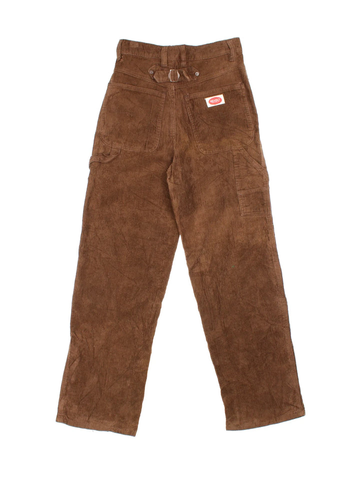 Vintage Revolt Corduroy Trousers in brown colourway with multiple pockets, back buckle and the logo embroidered on the front/back.