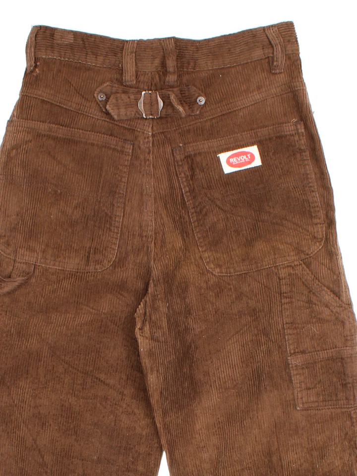 Vintage Revolt Corduroy Trousers in brown colourway with multiple pockets, back buckle and the logo embroidered on the front/back.